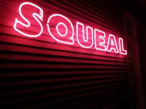 squeal red neon sign